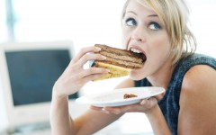 woman-eating-a-large-piece-of-cake