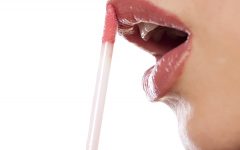 close up on a woman who applied lip gloss
