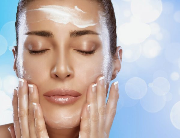Beautiful spa woman applying a spa treatment. Perfect skin. Skincare concept. Nude makeup