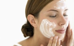 Young Woman Using Facial Cream