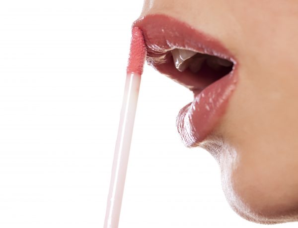close up on a woman who applied lip gloss