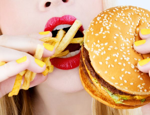 close-up of red lips eating junk food