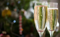 Two Champagne Flutes on Christmas Background with Xmas Tree